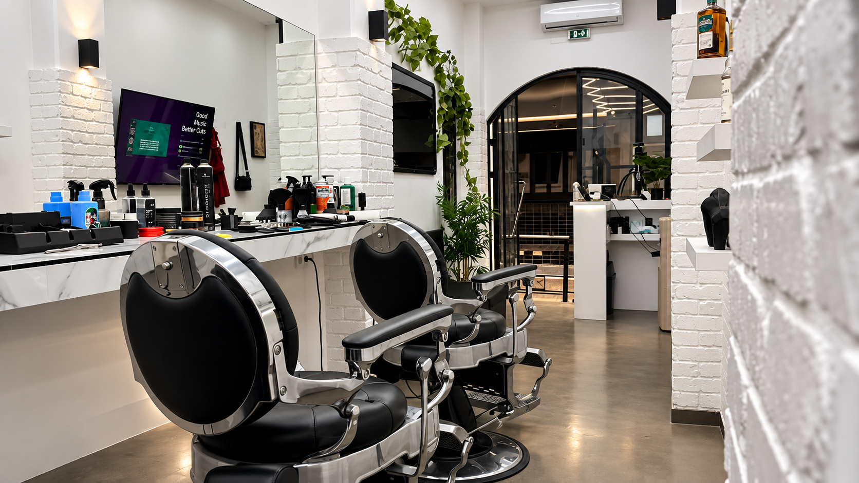Inside Ghost Barber Club — barber chairs and white brick walls